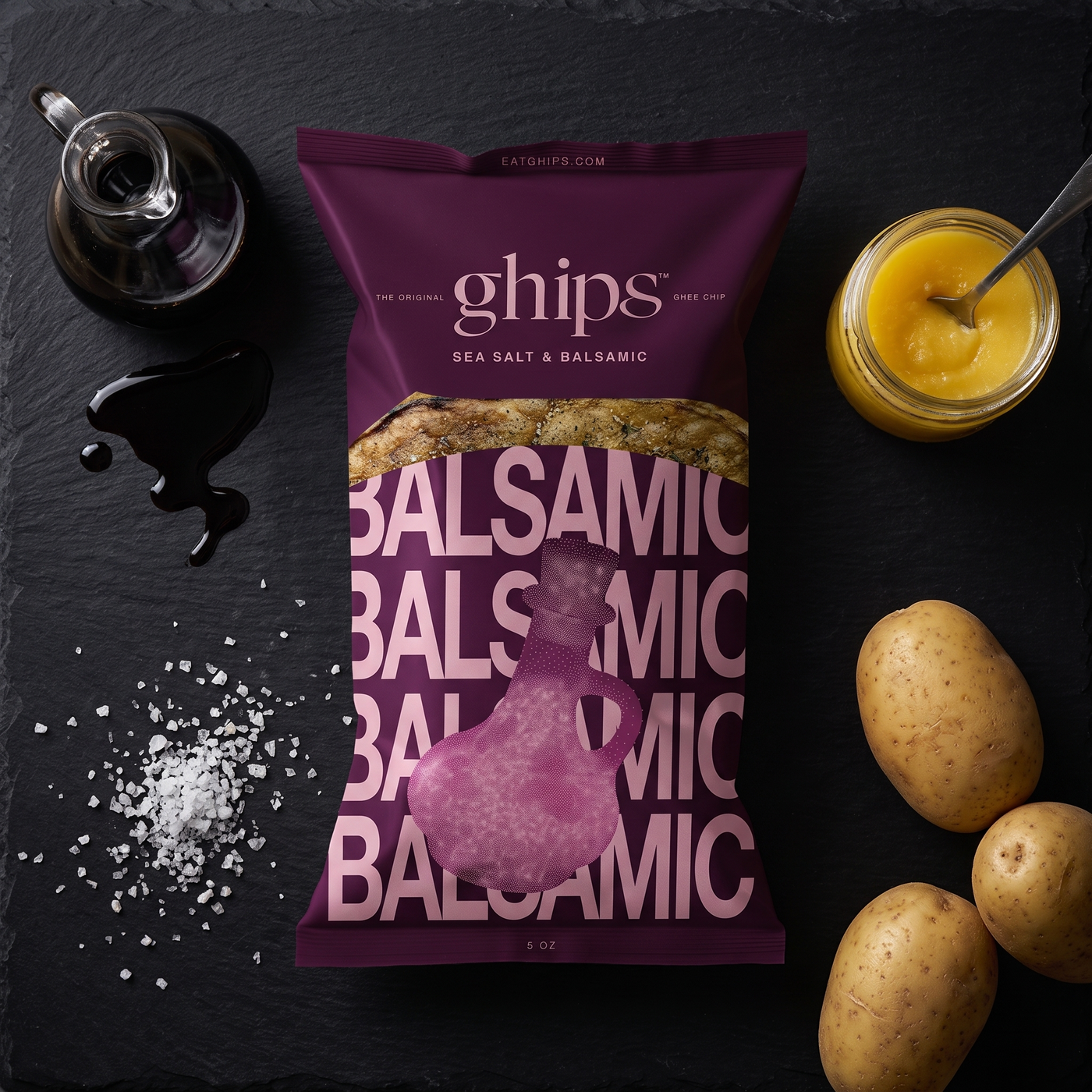 Ghips Sea Salt & Balsamic bag flat-lay with balsamic vinegar, sea salt, grass-fed ghee and organic potatoes on black slate